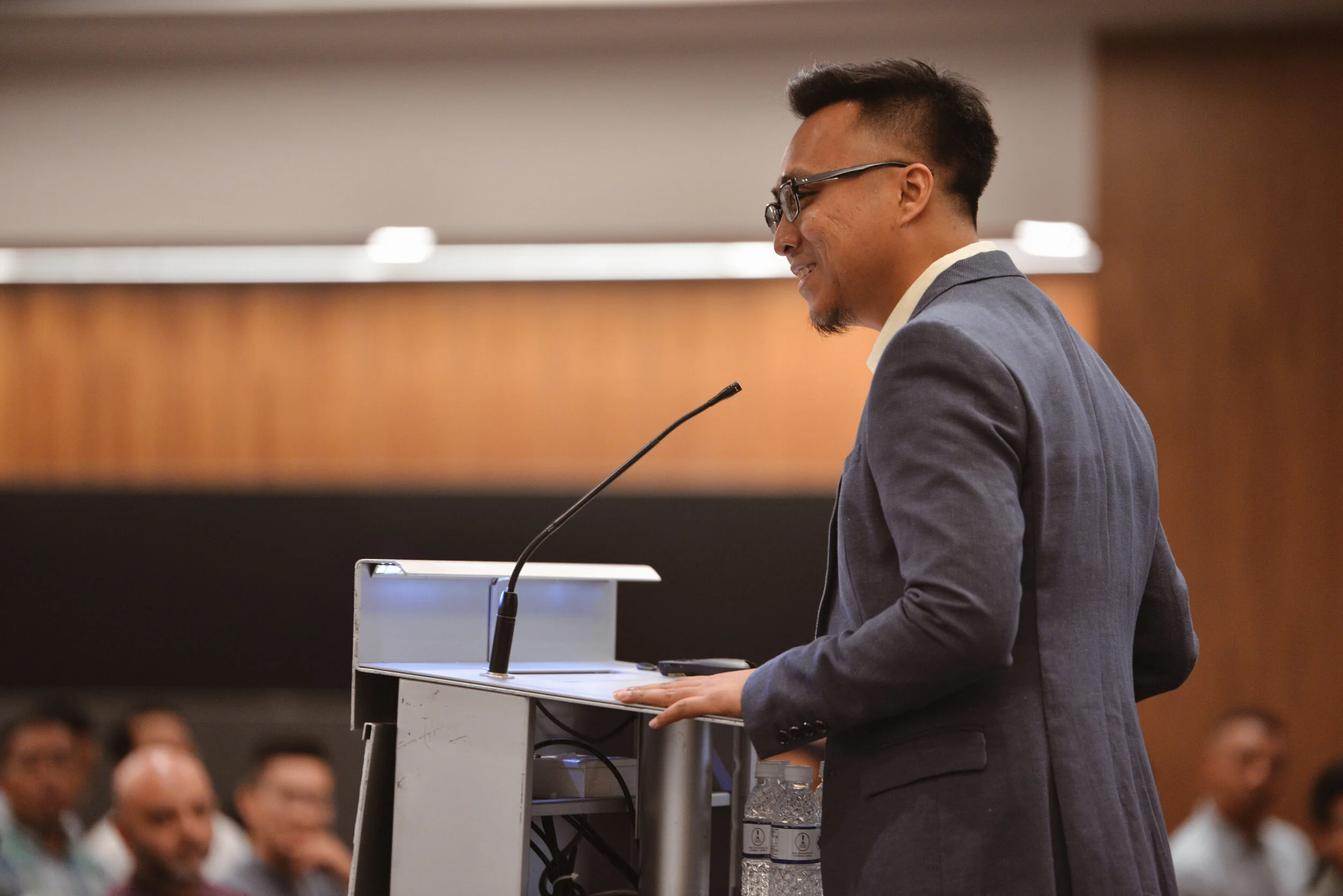 Mizi Wahid speaking on stage